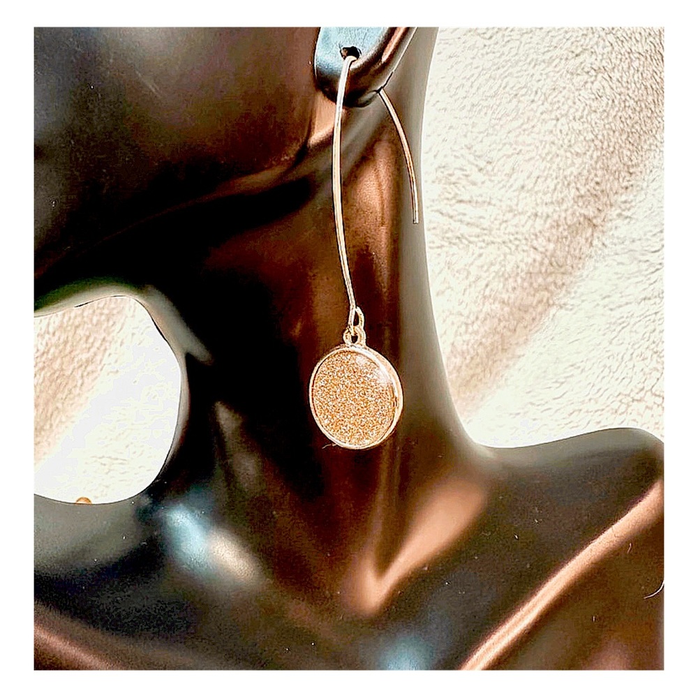 2.5" Shimmering, gold tone hook earrings.